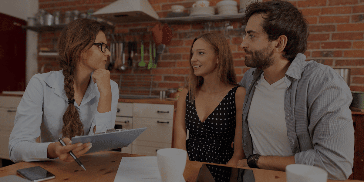 Couple speaking with real estate agent